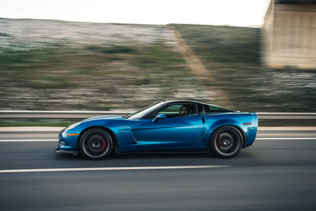 blue sports car speeding along