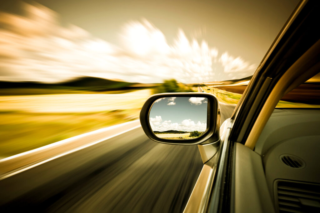 view of blurred trees as car speeds along